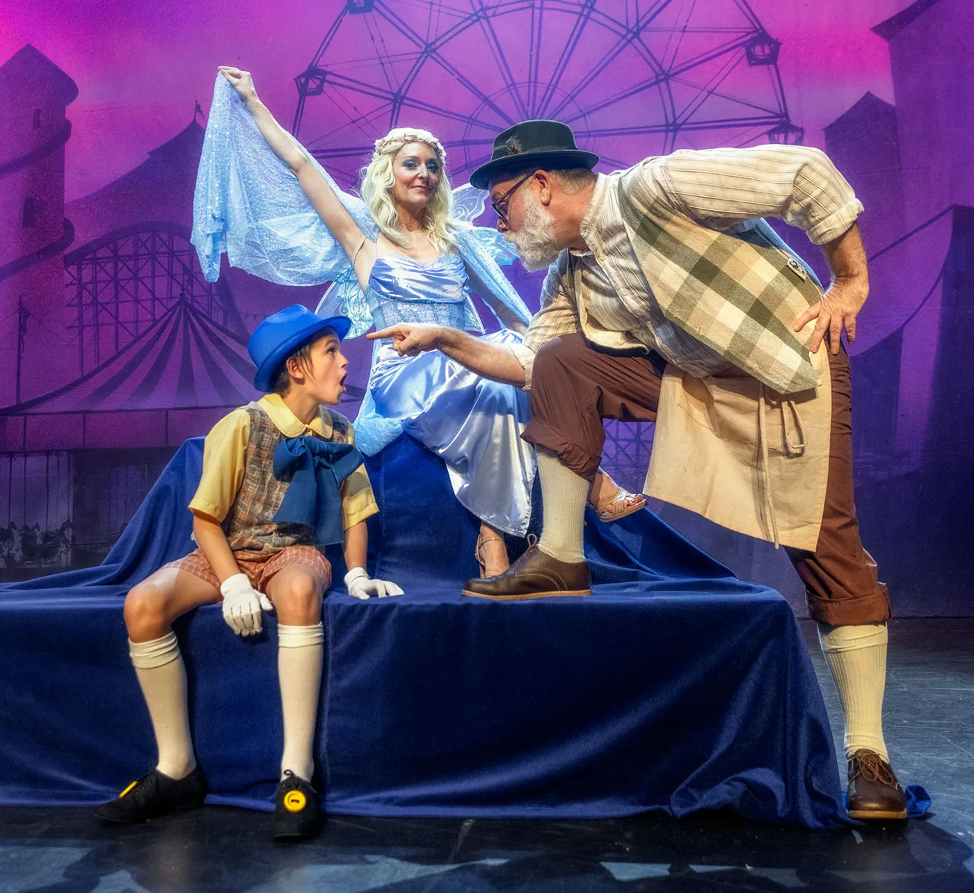 Pinocchio, Geppetto, and Blue Fairy on stage